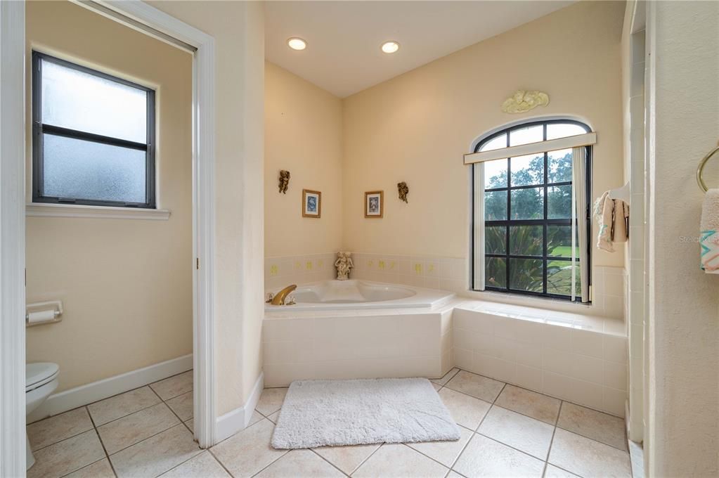 Master bath with garden tub and separate commode room.