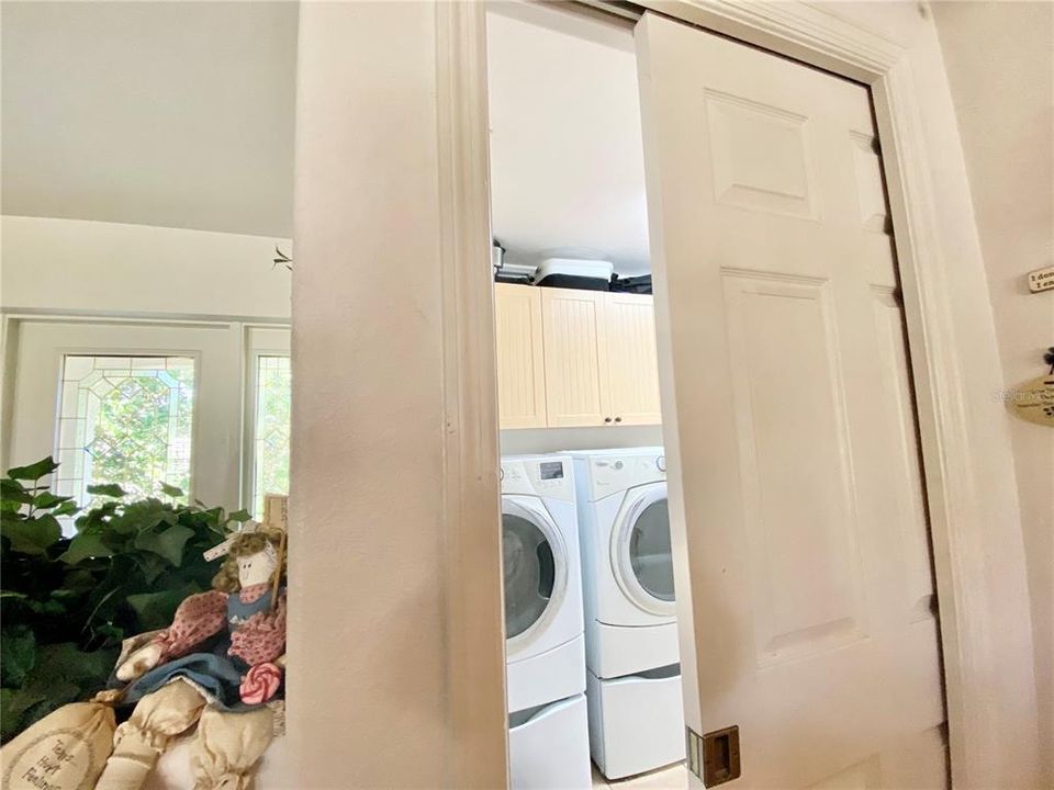 Laundry room entrance from the kitchen with a pocket door