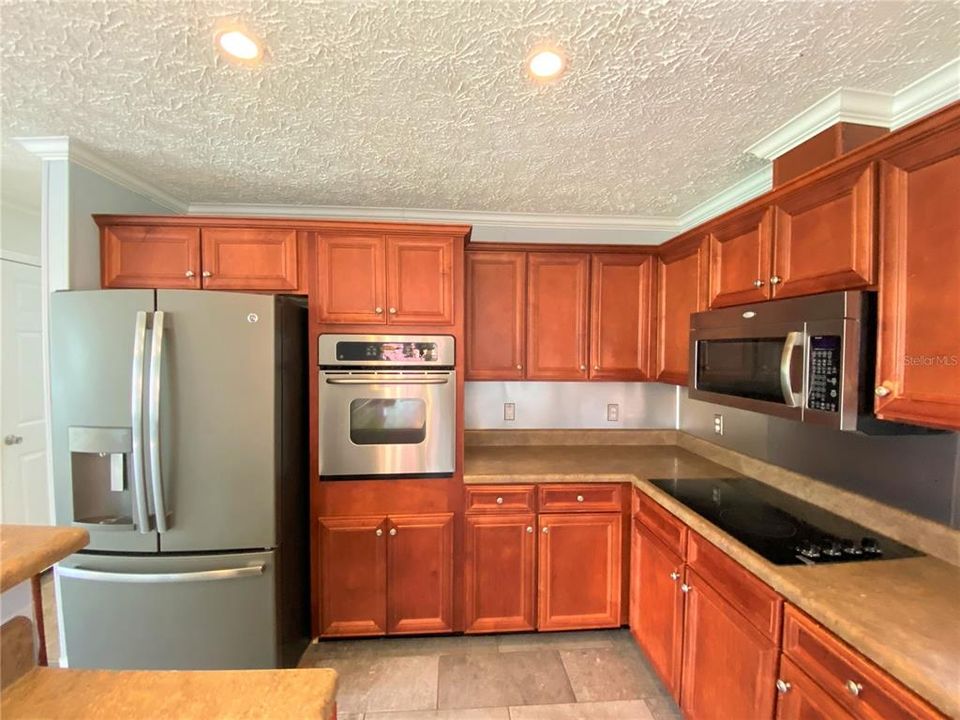 Stainless steel appliances and beautiful dark wood cabinets