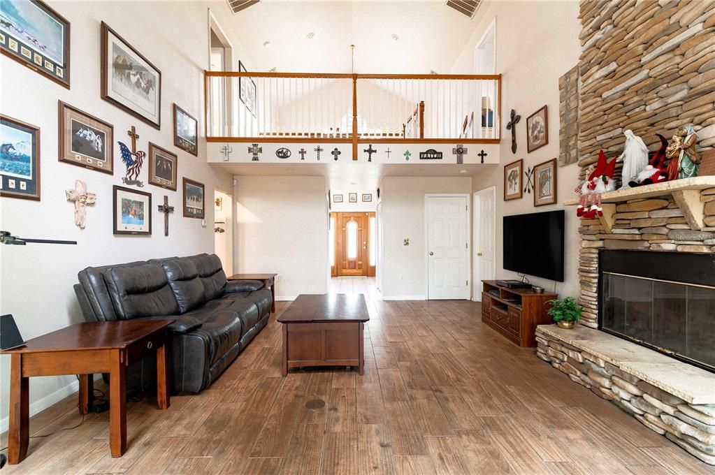 Living Room with view of upstairs balcony