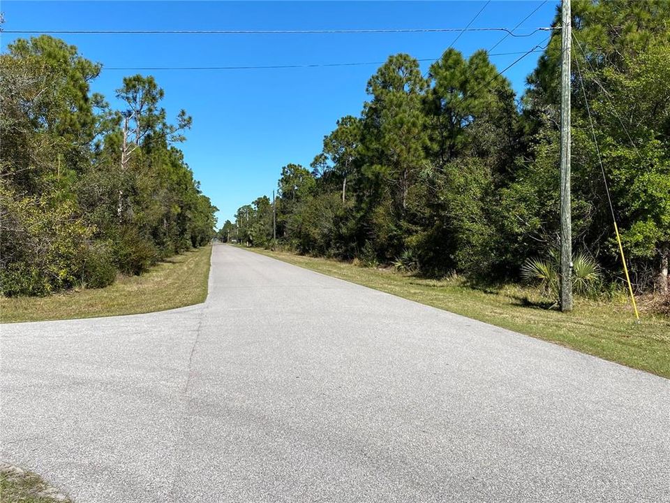 Lot is to the left past the utility pole.