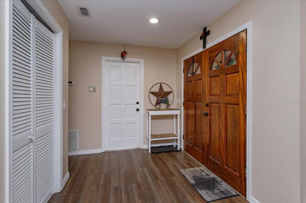 Foyer with coat closet and garage entry