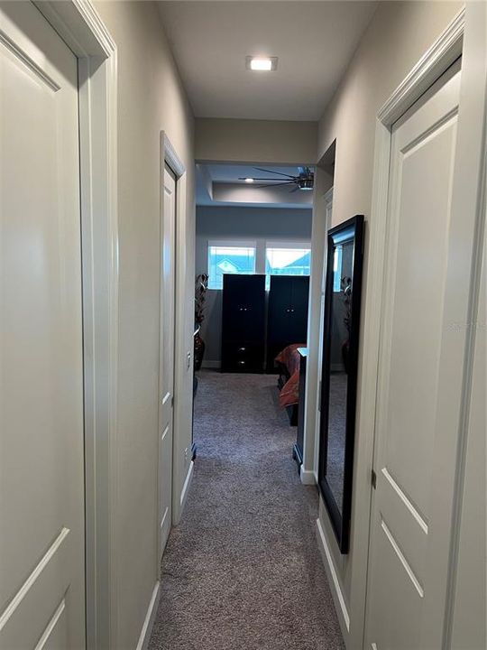 Master Bedroom Suite hallway with his and Hers closets on left. Master bath door on right.