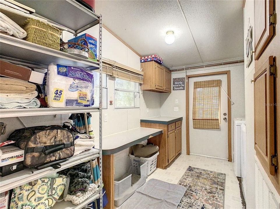 Laundry room with door leading to side yard