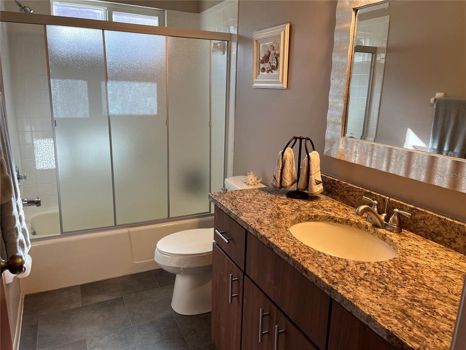 guest bath with updated vanity and new shower door