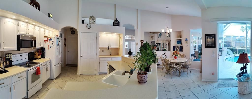 panoramic taken from family room showing open kitchen and dinette