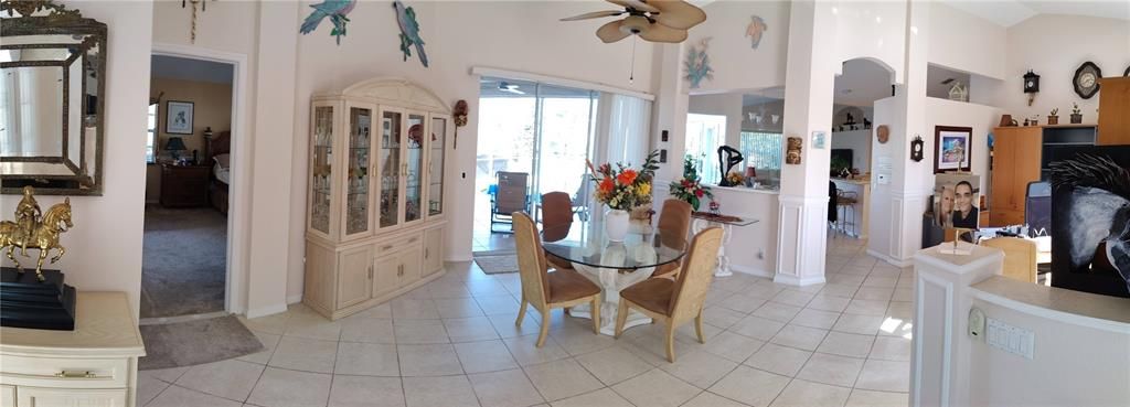 Panoramic view on Living room and dining room, used by owner as dining room and office