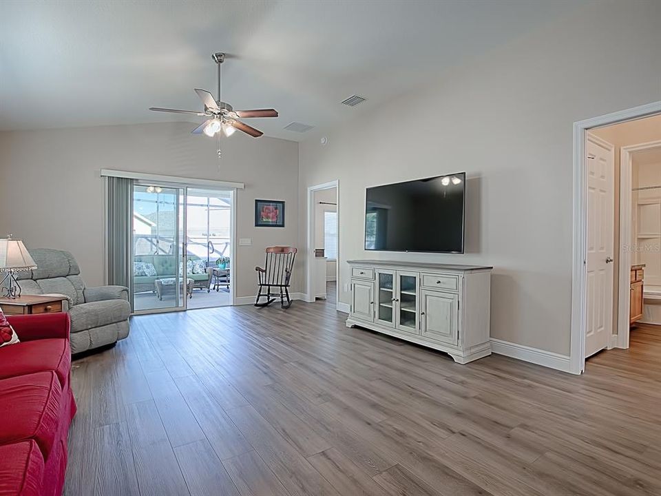 LIVING ROOM HAS LUXURY VINYL PLANK FLOORING THAT GOES THRUOUT THE ENTIRE HOME - NOTICE NO TRANSITION STRIPS!
