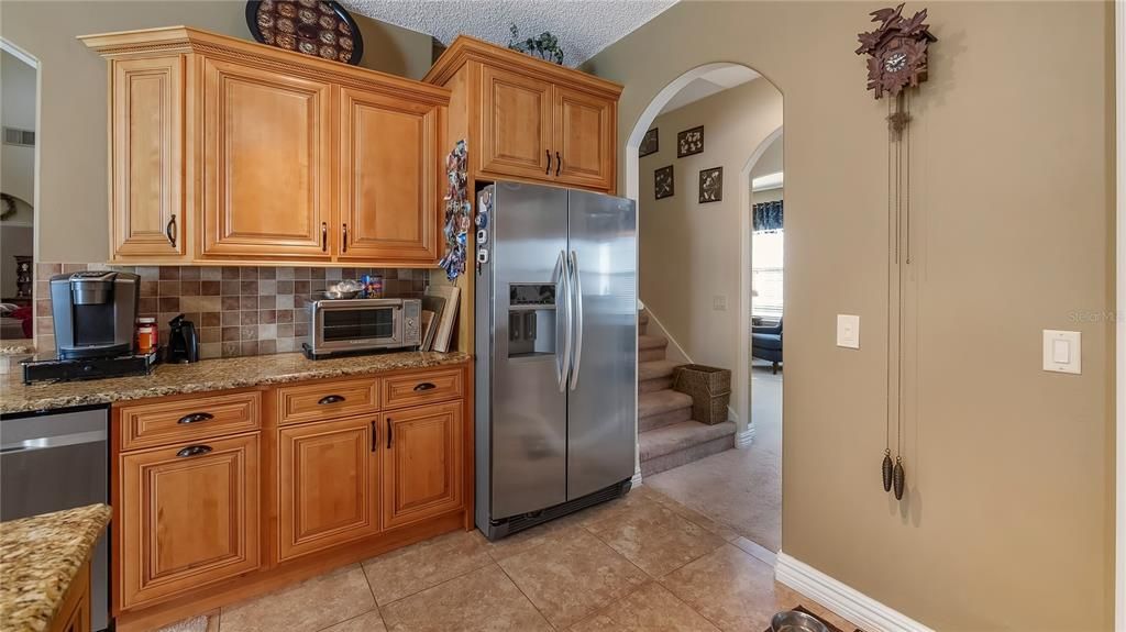 Kitchen with view of back staircase leading to upstairs