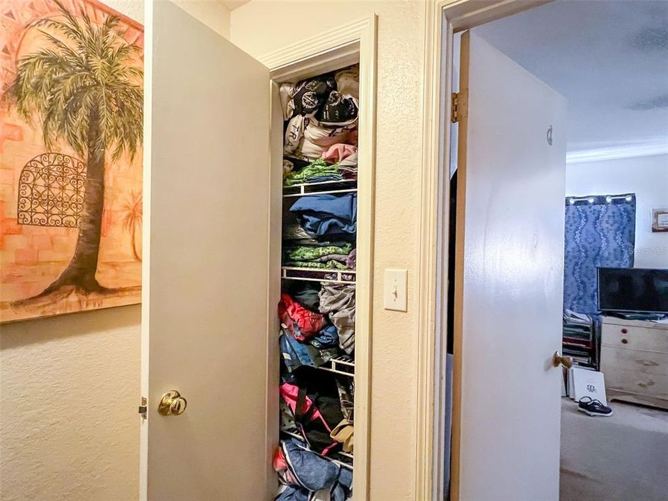 Linen closet at top of the stairs provides space to store towels and bedding