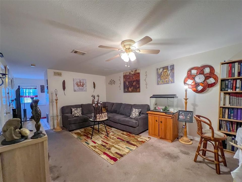 Living room, carpeted, with ceiling fan