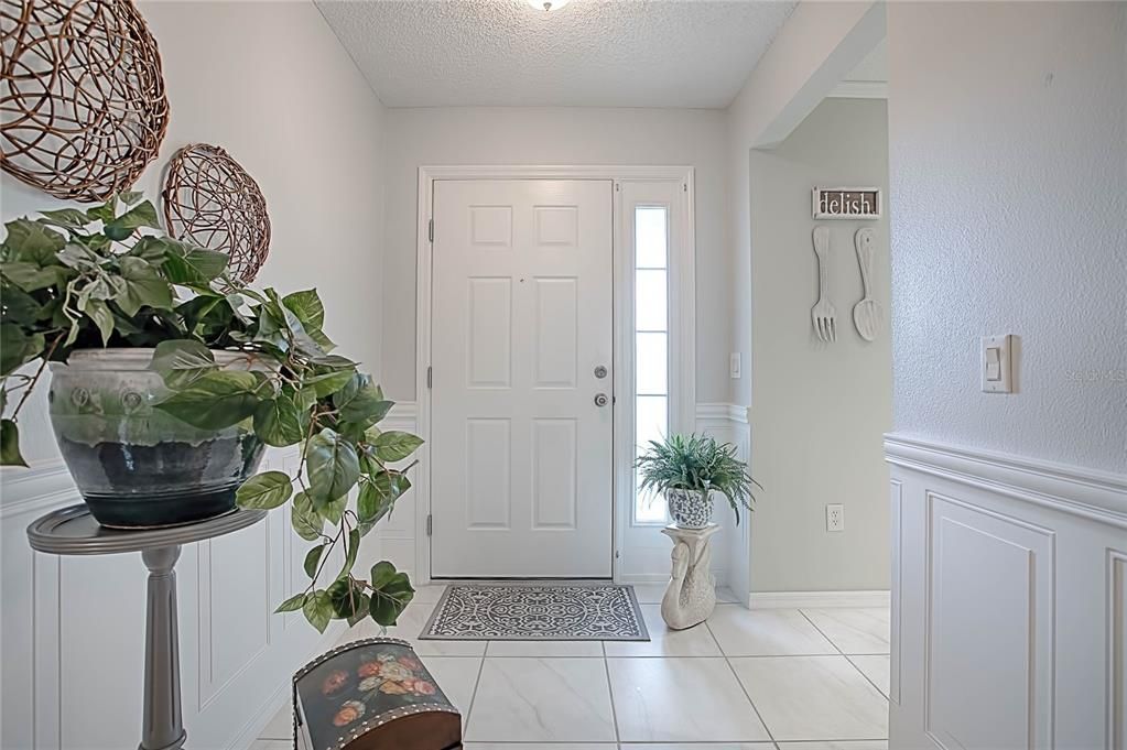 The elegant entry.  Notice the gorgeous picture frame wainscotting.