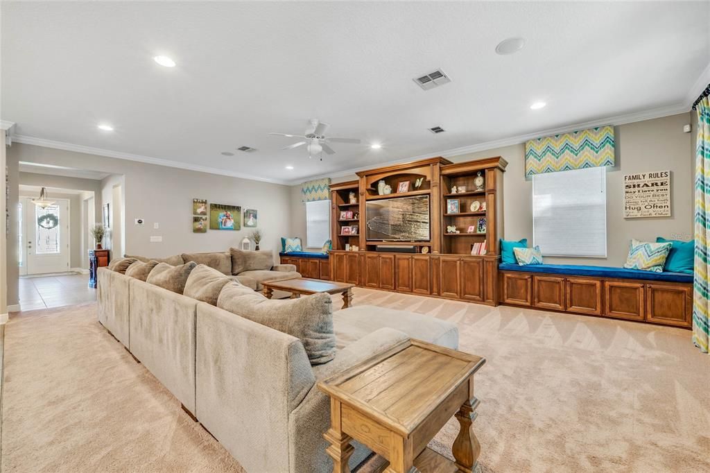 The spacious FAMILY ROOM with a wall to wall BUILT-IN that centers the space and gives you even more storage and shelving to display your favorite treasures!