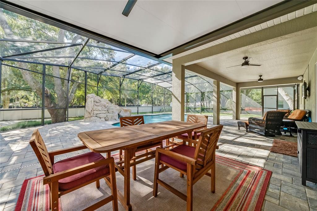 SLIDING GLASS DOORS off the kitchen give you access to the expansive COVERED LANAI with space for living and dining overlooking the gorgeous POOL!