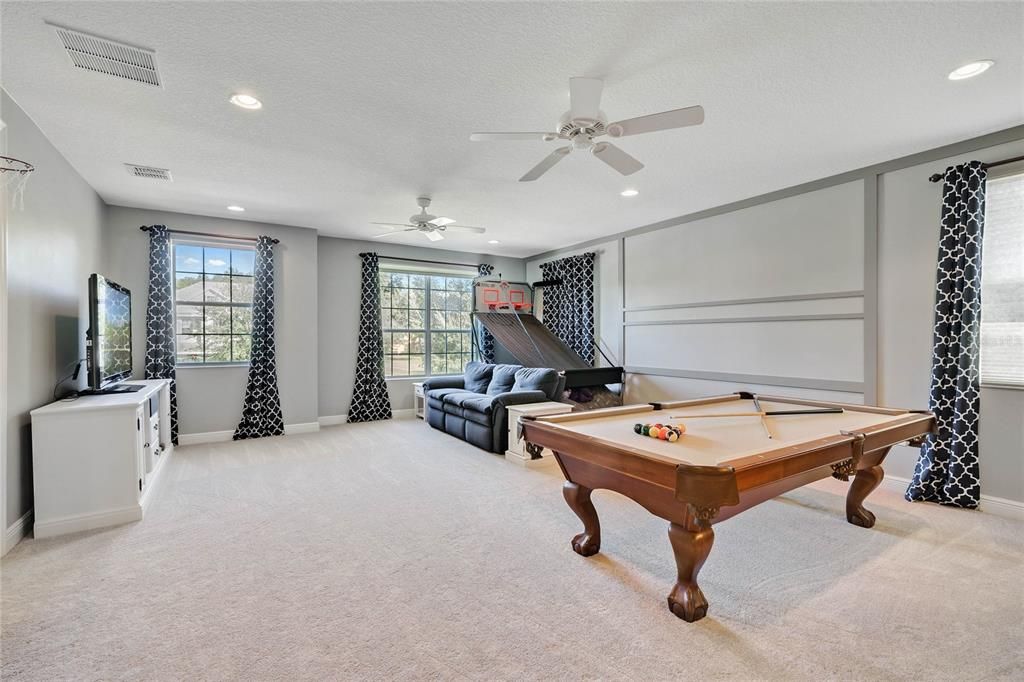 At the top of the stairs an enormous BONUS/LOFT space awaits, flexible living or a game room (there is a FULL WET BAR!) - the possibilities are endless!