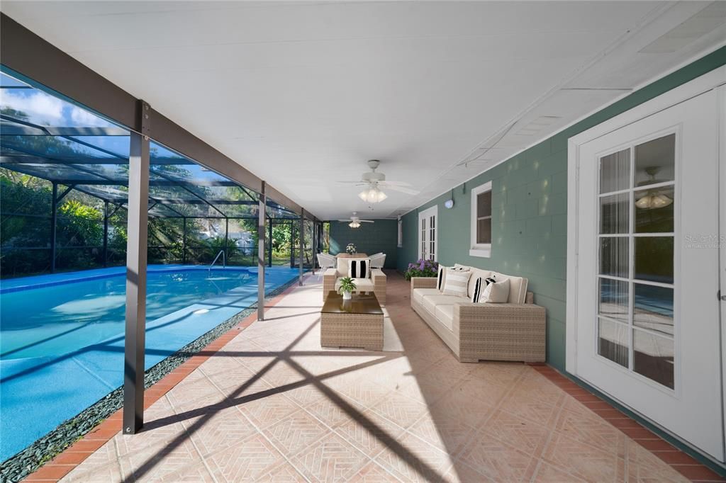 The expansive COVERED PATIO is a perfect place to relax in the shade poolside with family and friends! Virtually Staged.
