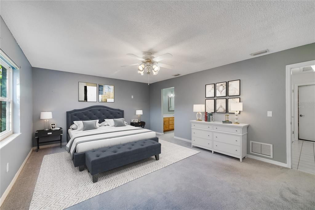The PRIMARY SUITE is generous and delivers an UPDATED EN-SUITE BATH with DUAL SINKS a TILED WALK-IN SHOWER and decorative mirrors and a WALK-IN CLOSET! Virtually Staged.