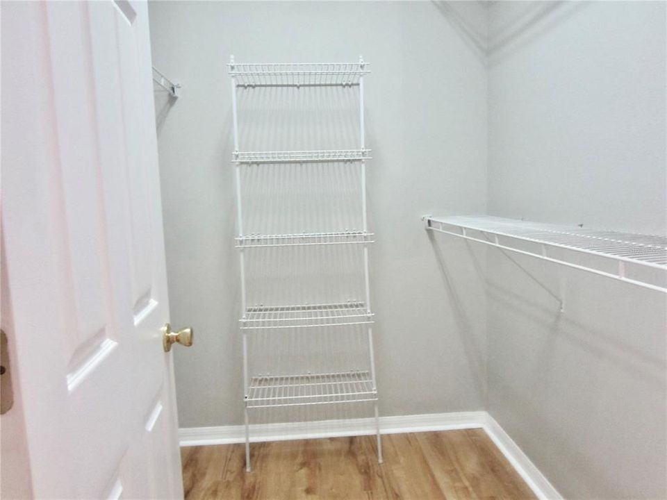 a walkin closet for him in master bedroom