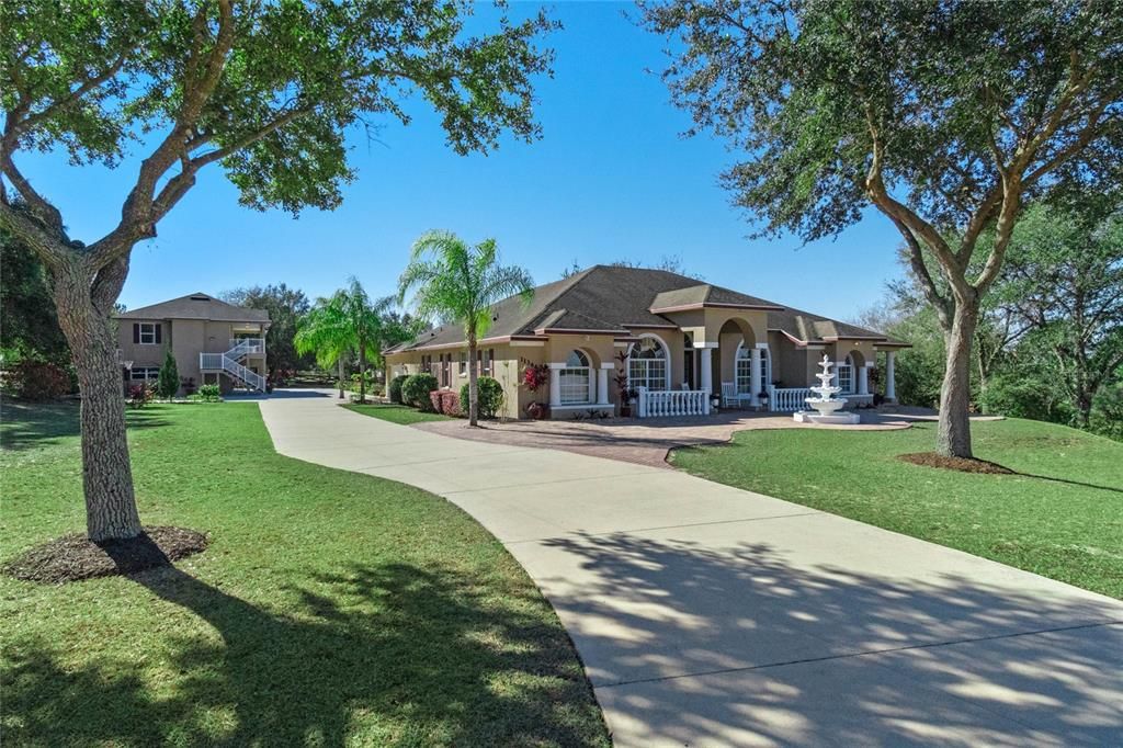 Pristine curvy driveway with paver accents