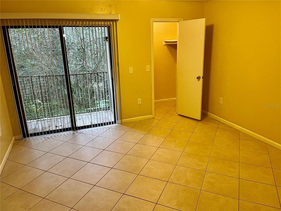 Bedroom with walk in closet and balcony