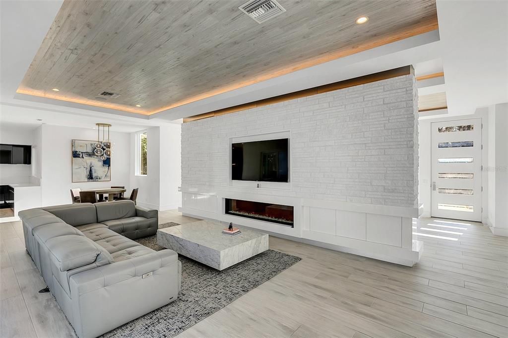 Family room with Built in Audio/Visual and decorative fireplace.