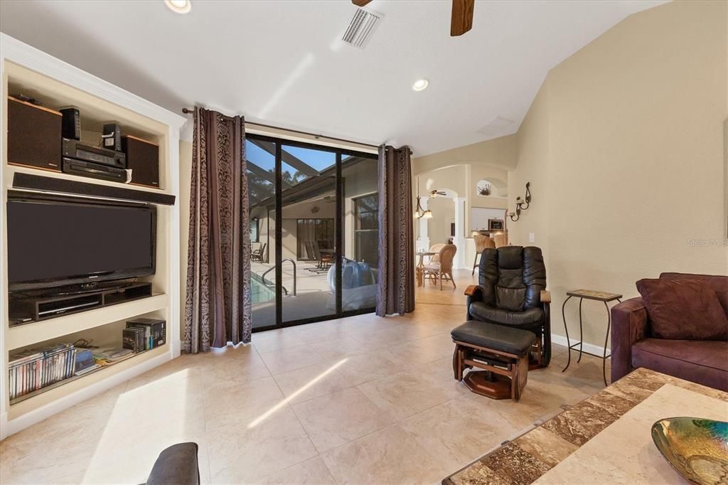 behind kitchen/nook is your spacious family room with another set of sliders to pool and lanai