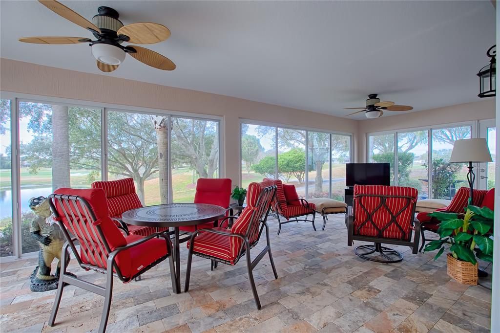 Stretched glassed enclosed Lanai with travertine flooring over looking your golf and water view