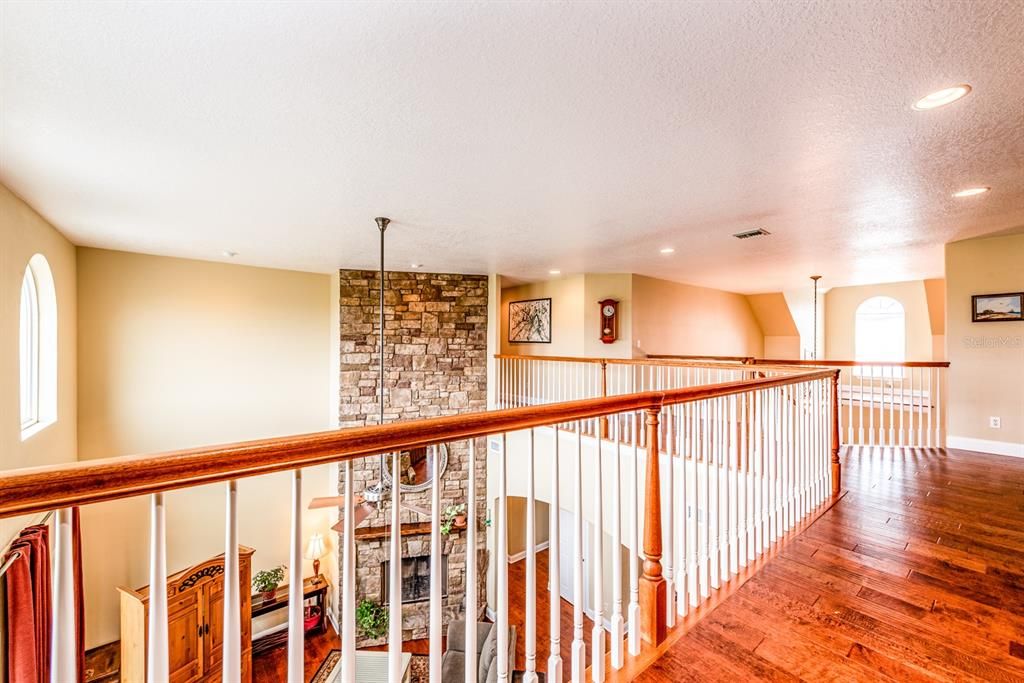 Second floor landing showcases the soaring ceilings open to the main floor!