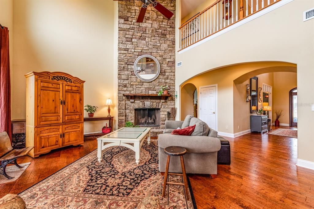 The FAMILY ROOM centered by the STONE FRONT FIREPLACE that extends all the way to the ceiling and a wall of windows let the NATURAL LIGHT pour into the space!