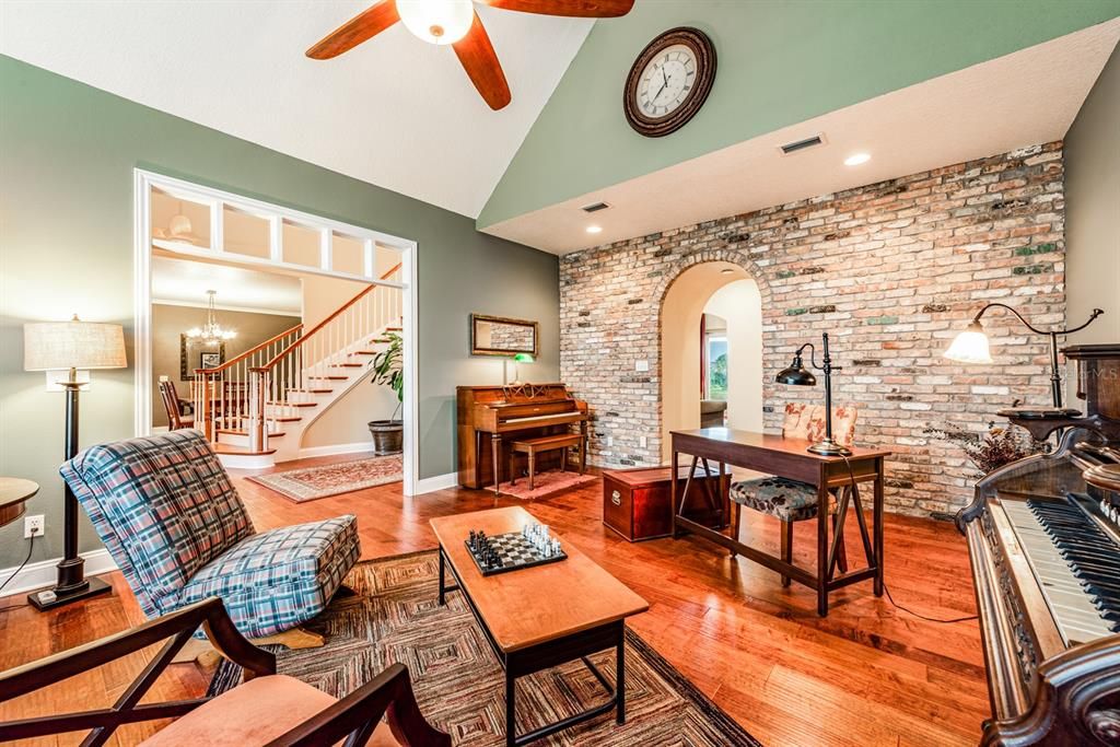 To the right you will find a flexible living space in the LIBRARY complete with a GENUINE CHICAGO BRICK WALL, VAULTED CEILING and ARCHED DOORWAY for that extra bit of magic.