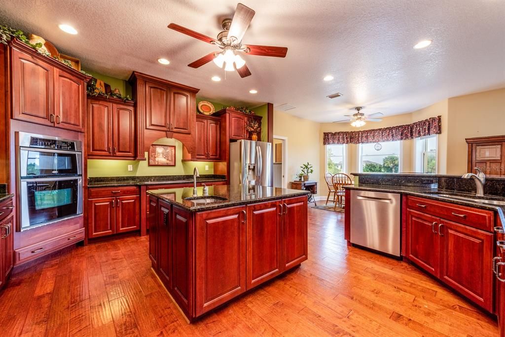 The family chef will absolutely fall in love with this GOURMET KITCHEN boasting GRANITE COUNTERTOPS, upgraded STAINLESS STEEL APPLIANCES including a CONVECTION OVEN & large ISLAND!