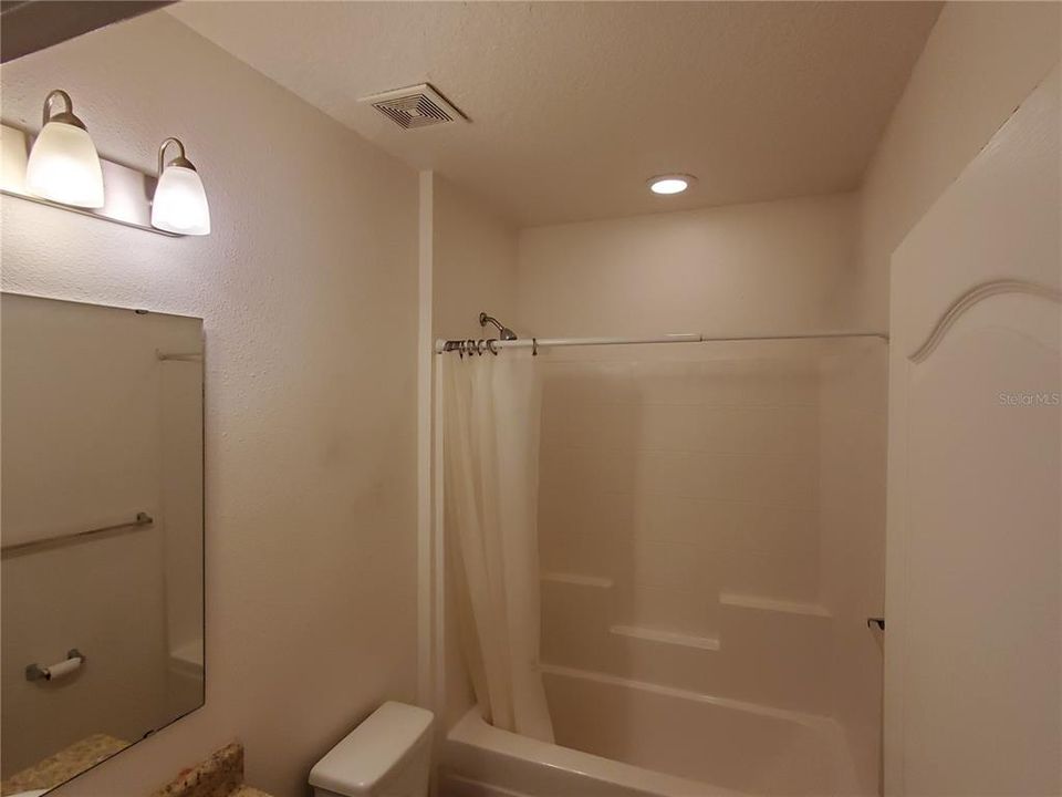 Hall bathroom has tub/shower and ceramic floor