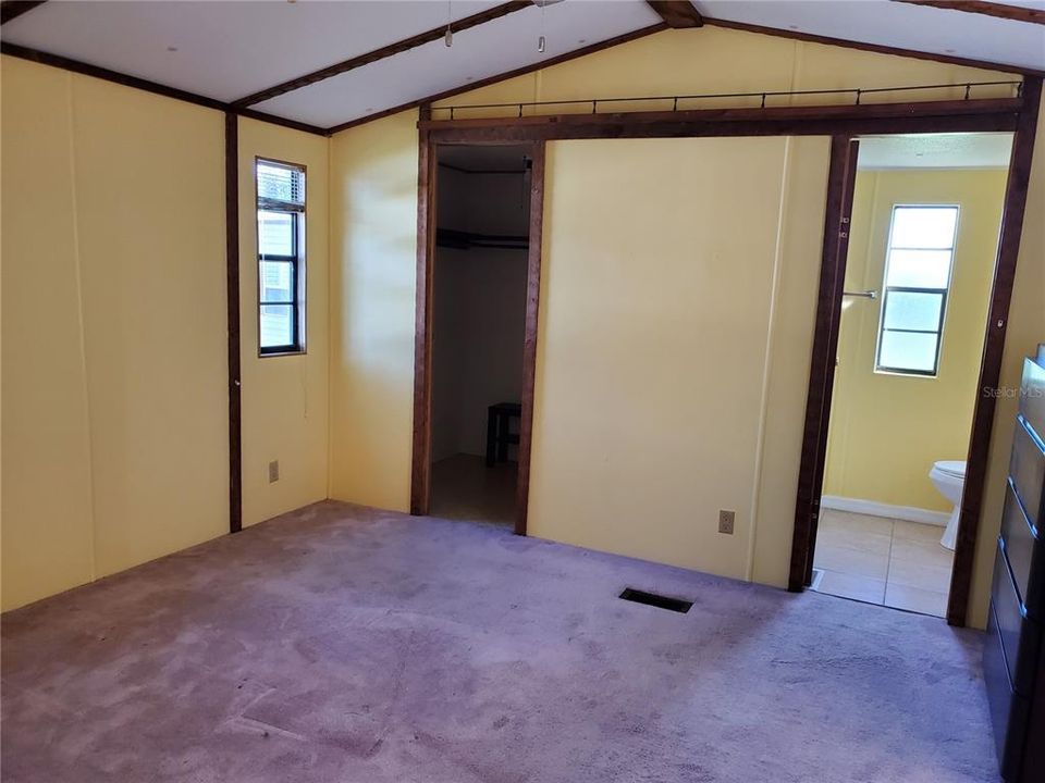 Large bedroom with great bathroom.  Walk in closet Carpet looks purple, but it is brown.