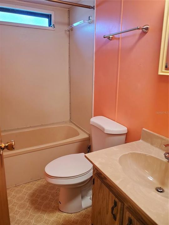 Guest bathroom with tub and shower