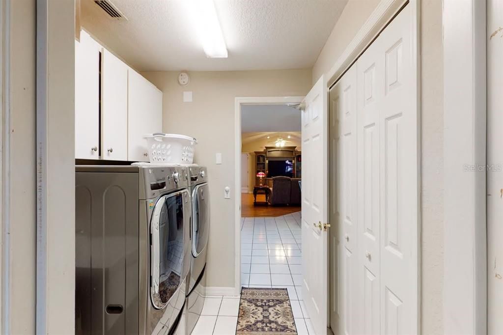 Laundry Room with Overhead Cabinets and Closet