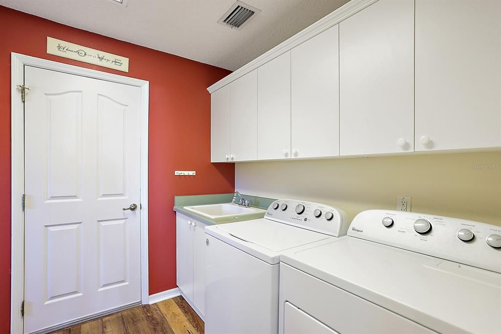 Inside Laundry Room with Utility Sink and Extra Cabinets