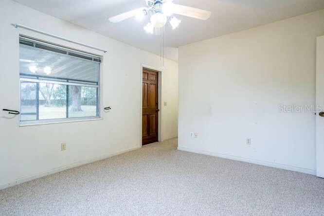 master bedroom with access door to screened porch