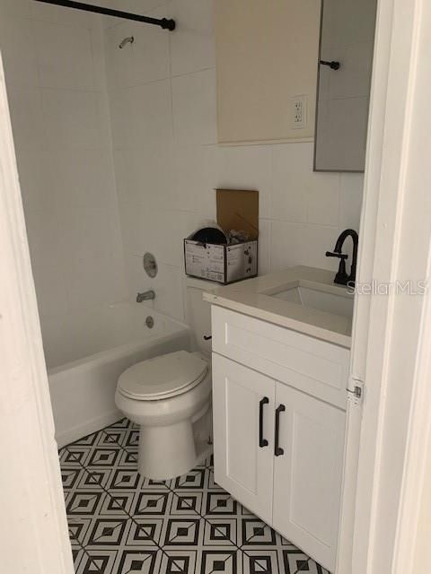 Bathroom with new tile floors and cabinet