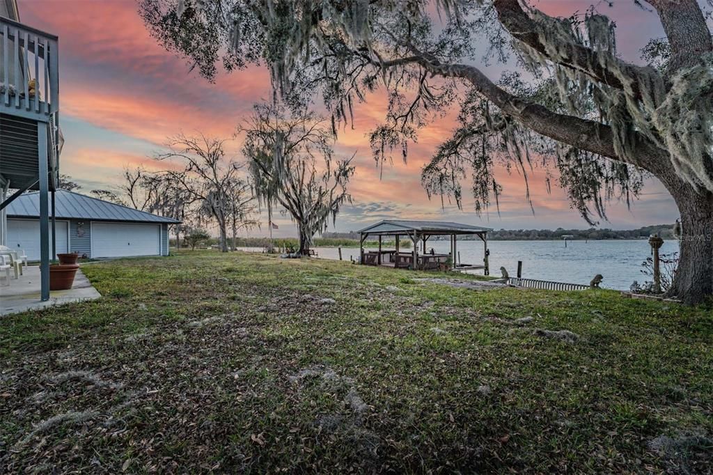 View of land, dock and detached garage.