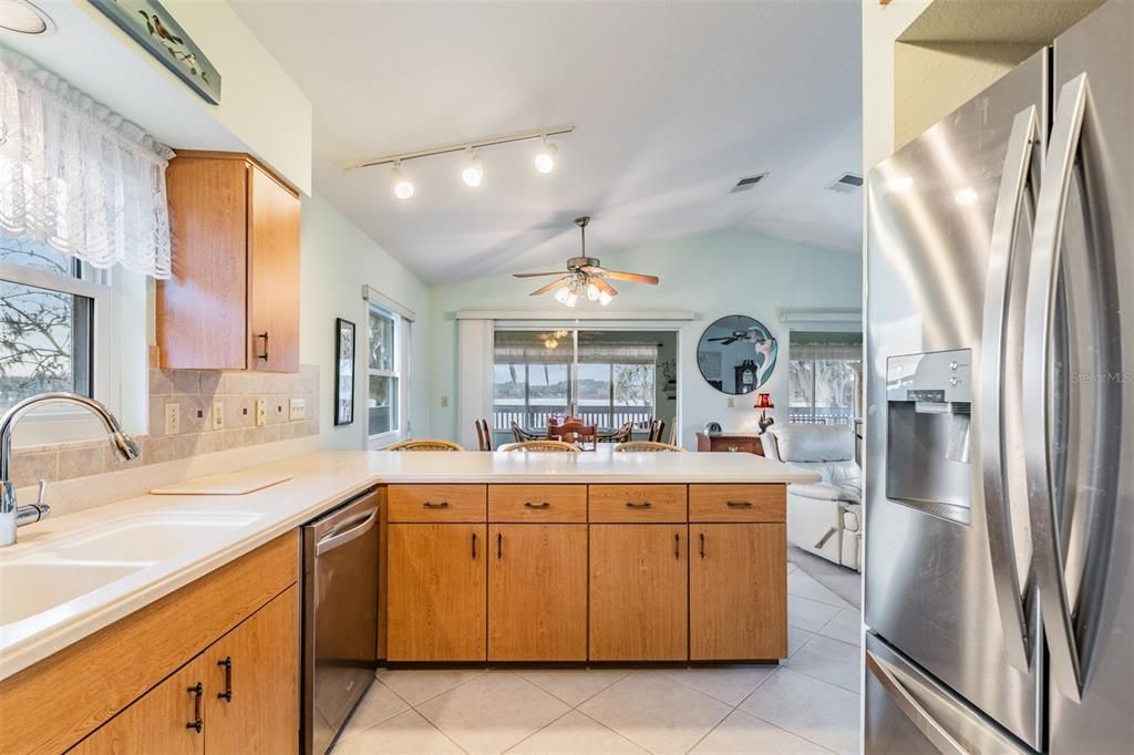 Kitchen open to the Dining Room and Enclosed patio and Lake Views.