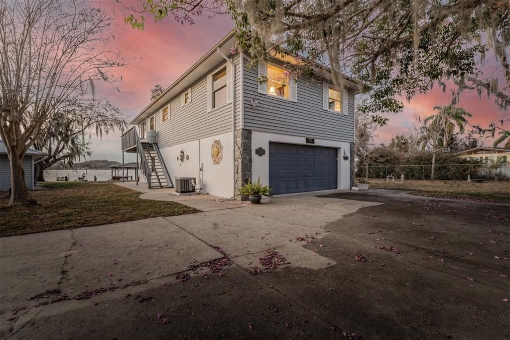 Front Exterior - Metal Roof on the home and the detached garage, 3 bedrooms, 3 bathrooms, 2 car attached garage and another detached 2 car garage on the left, boat dock including sink.