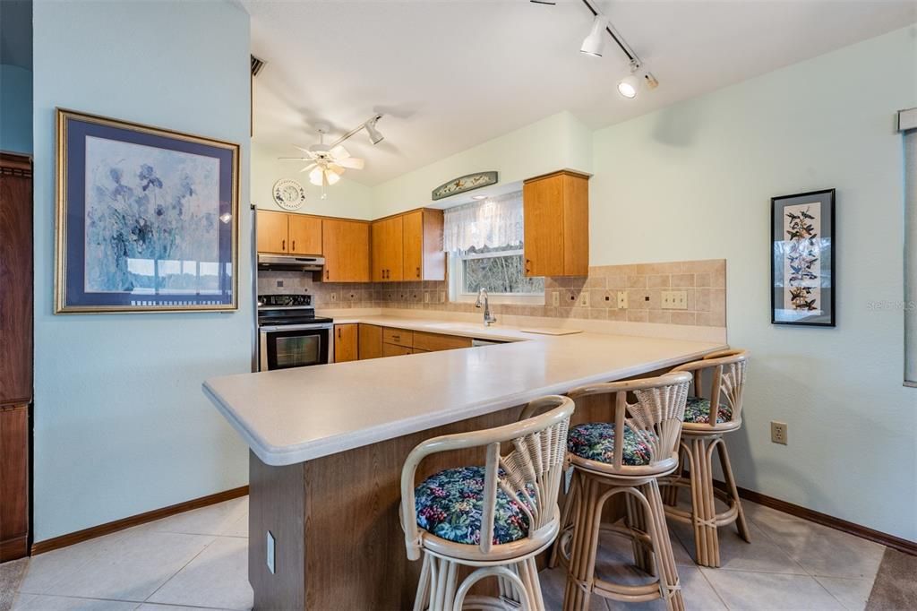 Kitchen bar and open to the dinette and family room