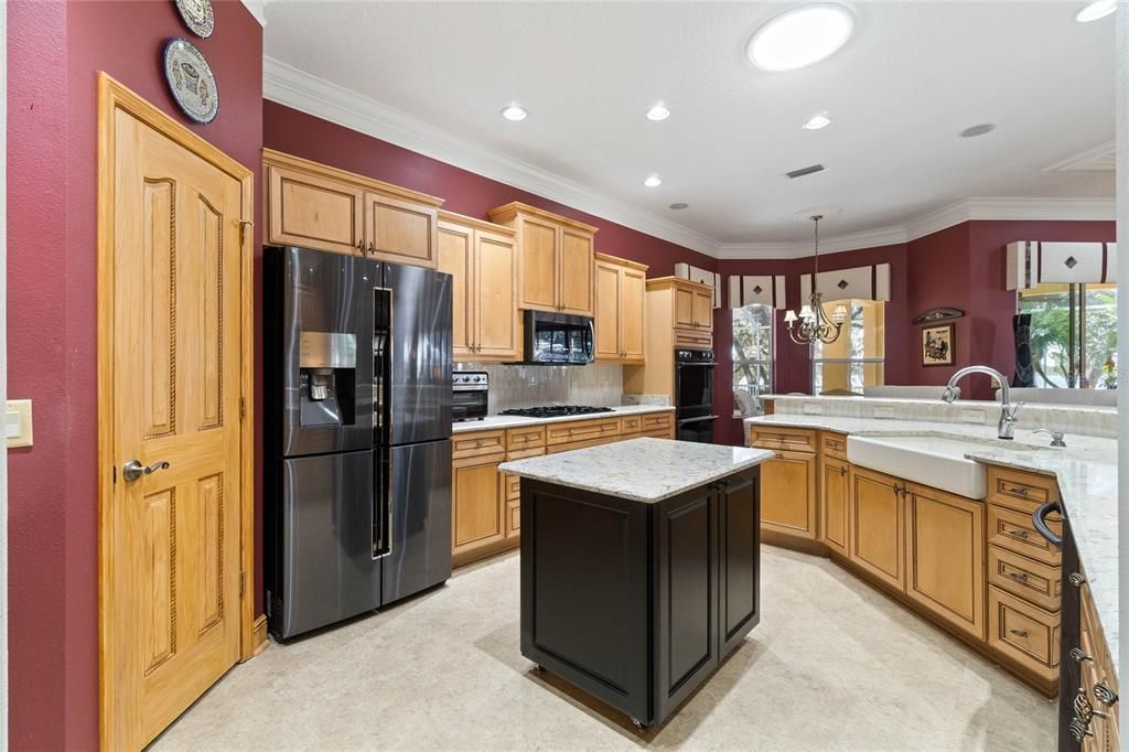A Gourmet Kitchen Boast Two Convection Ovens ,surrounded by Glazed Rope Maple cabinetry, thick Quartz Counters & newer S/S Appliances.