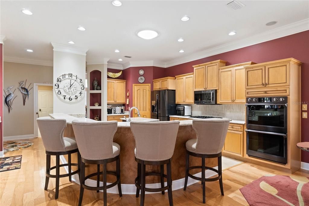 Wrap around kitchen island as that is where all guests gather.