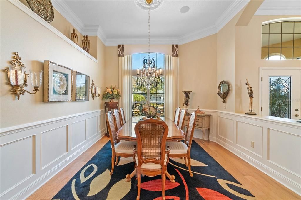 Formal Dining Room is a winner with Chandelier & architectural wall panelling.