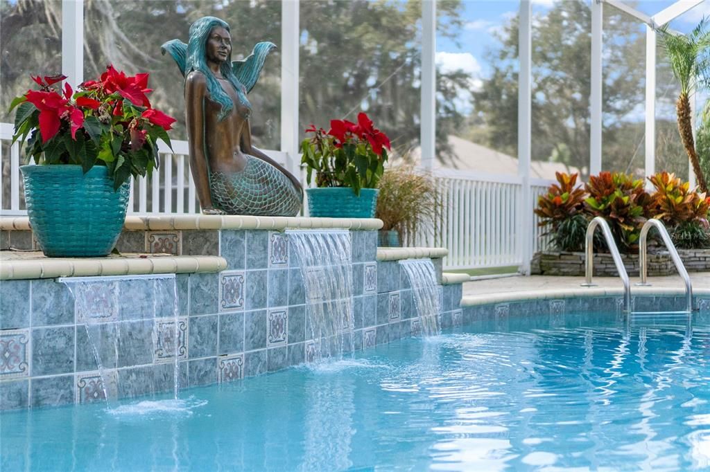 Relax in the pool under the canopy of the Granddaddy Oaks where the light wind  whispers by.