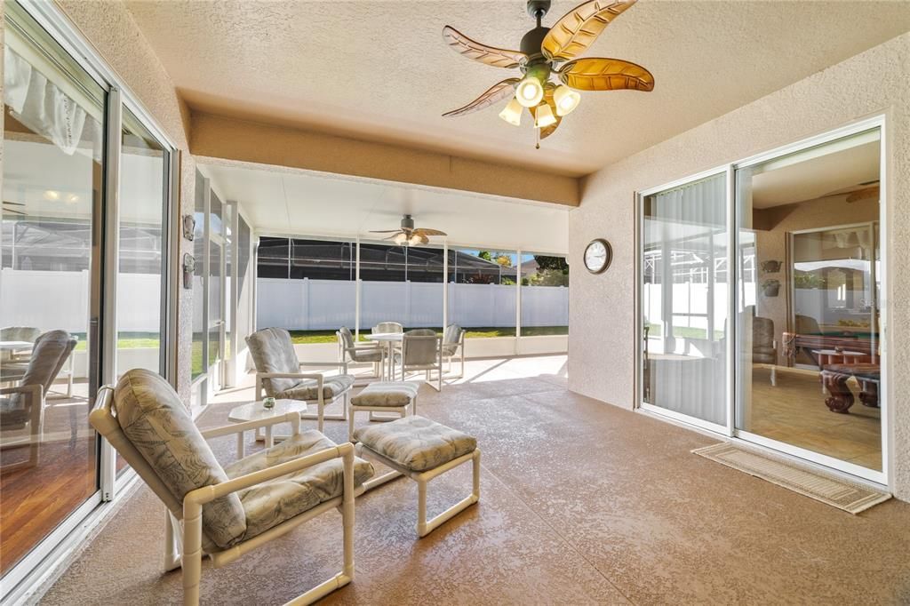 Multiple sliding glass doors grant you access to the EXTENDED SCREENED LANAI - a perfect place to cookout and relax at the end of a long day overlooking your FULLY FENCED backyard!