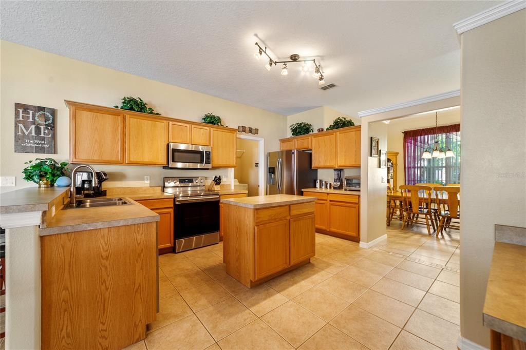 The space in this kitchen can’t be beat, the family chef will fall in love with the endless cabinet and counter space, the ISLAND and PANTRY for additional storage plus BREAKFAST BAR and DINETTE seating for casual dining.
