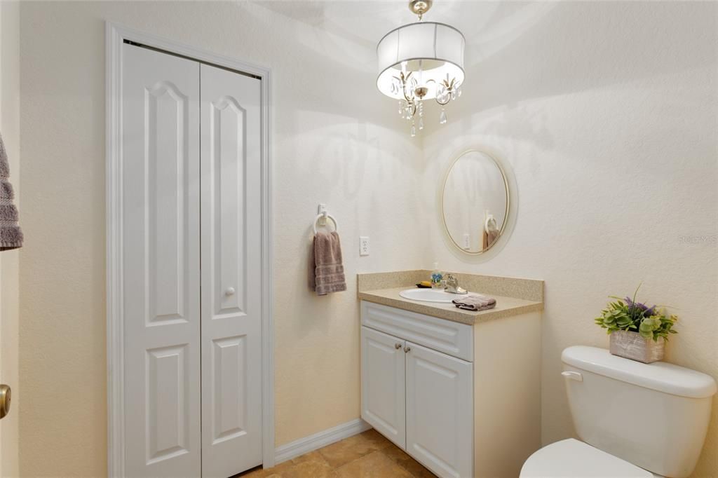 Half bath downstairs with a chandelier for opulance