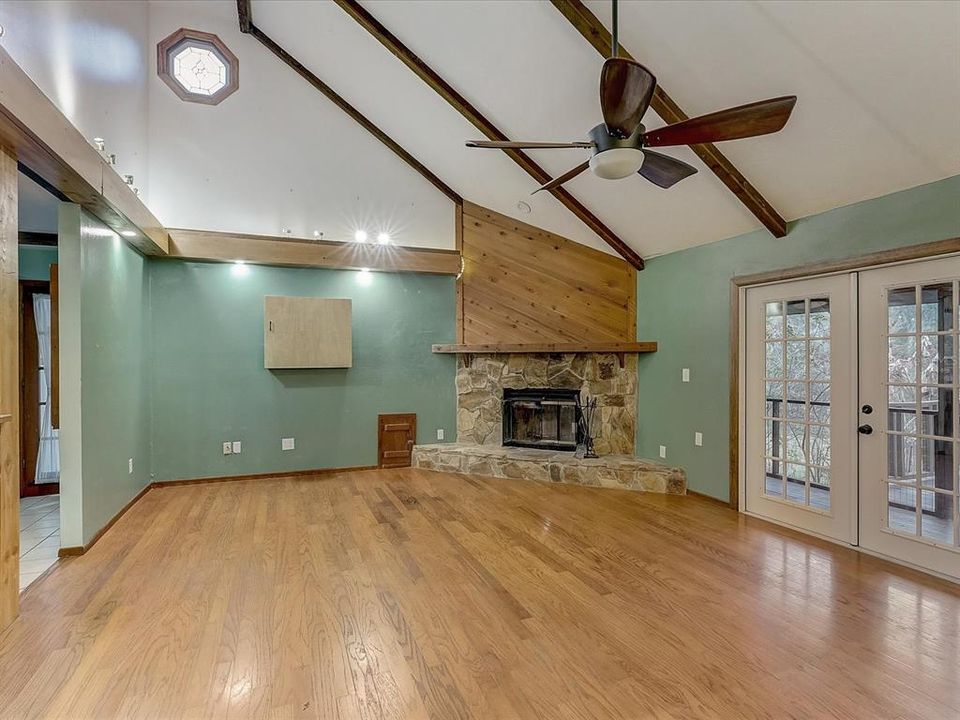 Open great room with vaulted ceilings and fireplace